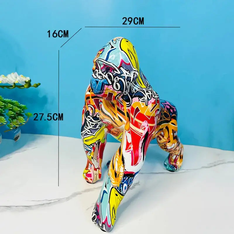 Vibrant resin gorilla sculpture with bold yellow red and blue graffiti designs for living room decor by decorbites
