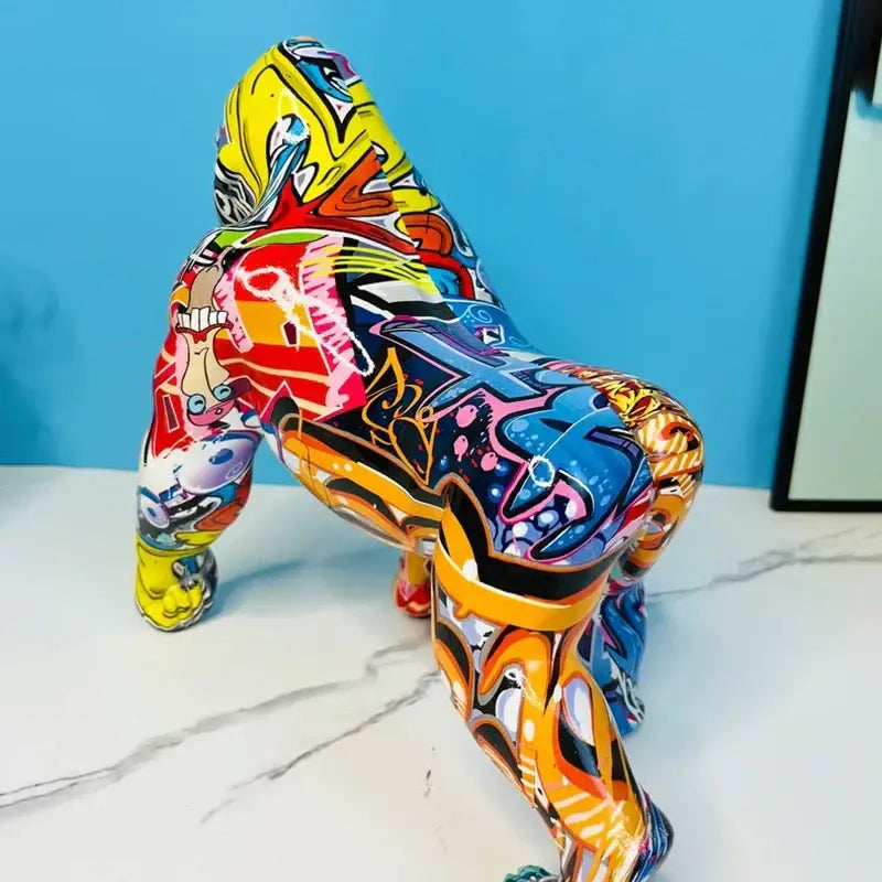 Vibrant graffiti street art gorilla sculpture in bold yellow red blue and orange on glossy resin decorbites gorilla sculpture