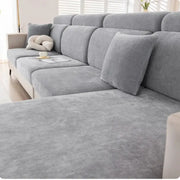 Gray and beige chenille universal sofa cover on textured fabric sofa with matching cushions for living room use