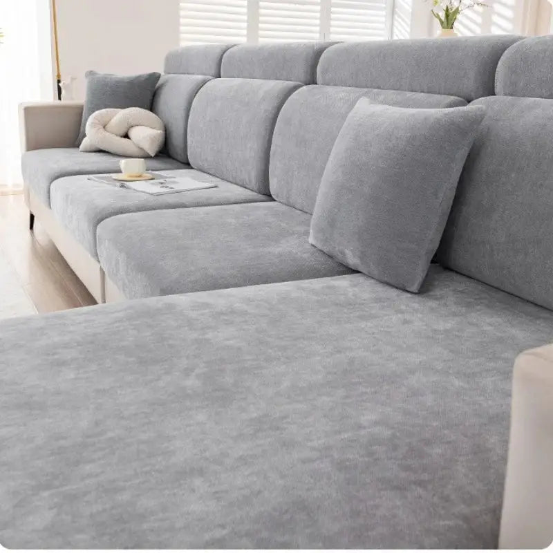 Gray and beige chenille universal sofa cover on textured fabric sofa with matching cushions for living room use