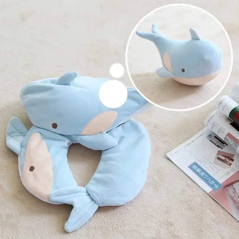 Light blue plush whale neck pillow with soft rounded features and beige underbelly by decorbites cute plush animal