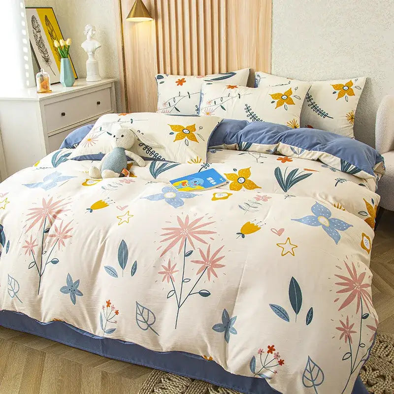 Cream-colored floral duvet cover with pink blue and yellow blossoms on soft cotton fabric in green leaf print bedding set