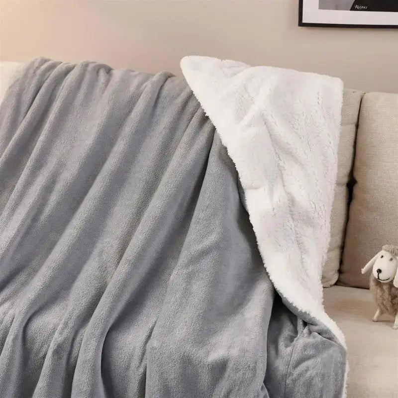 Gray and white reversible sherpa twin blanket with soft plush fleece texture for cozy bedroom use