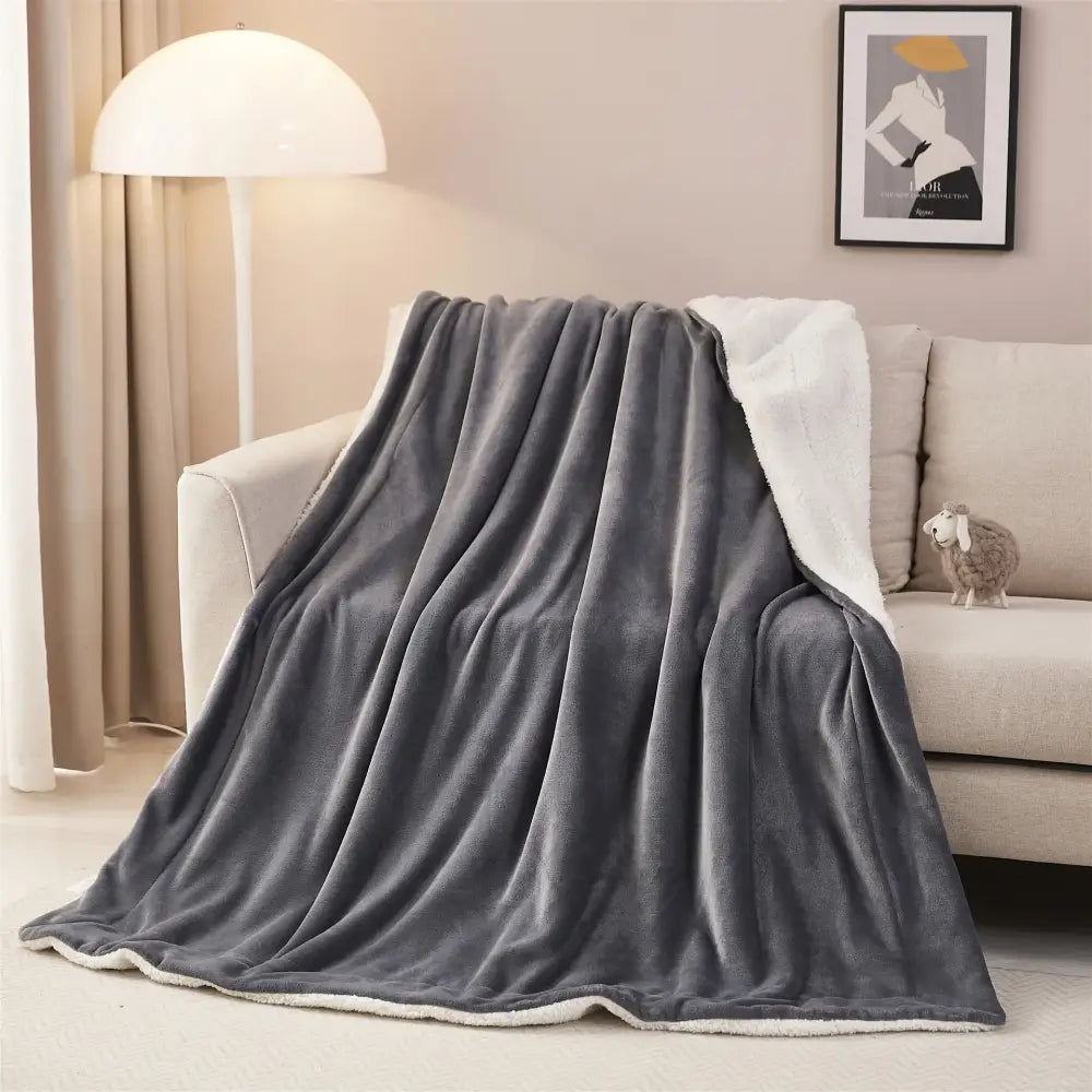 Gray and white reversible sherpa twin blanket with soft textured exterior and white sherpa lining for bedroom throw