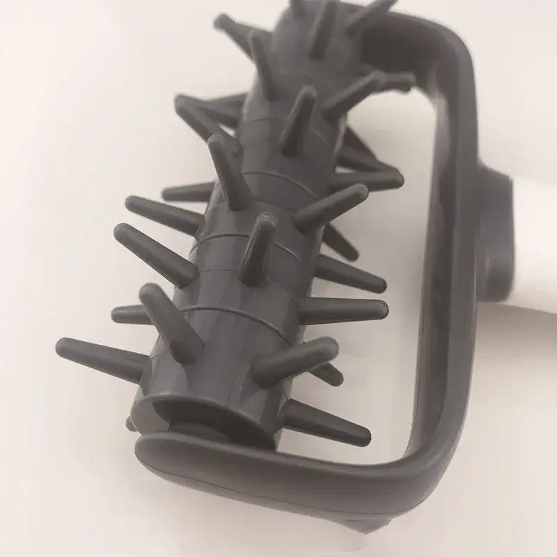 Black plastic massage roller with handle and spiked protrusions displayed alongside a gray and white silicone dough roller pastry tool decorbites dough roller