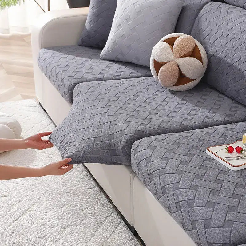 Gray and white woven elastic sofa slipcover with a textured interlaced pattern for living room use