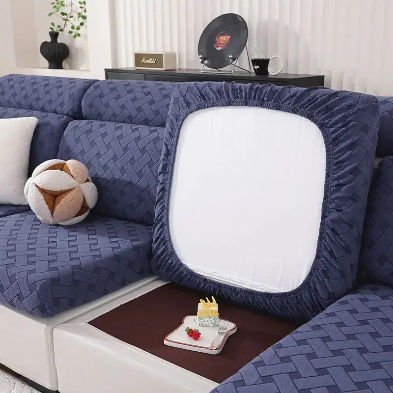 Navy blue quilted fabric sofa cover with a white central panel and elasticated edges for living room use