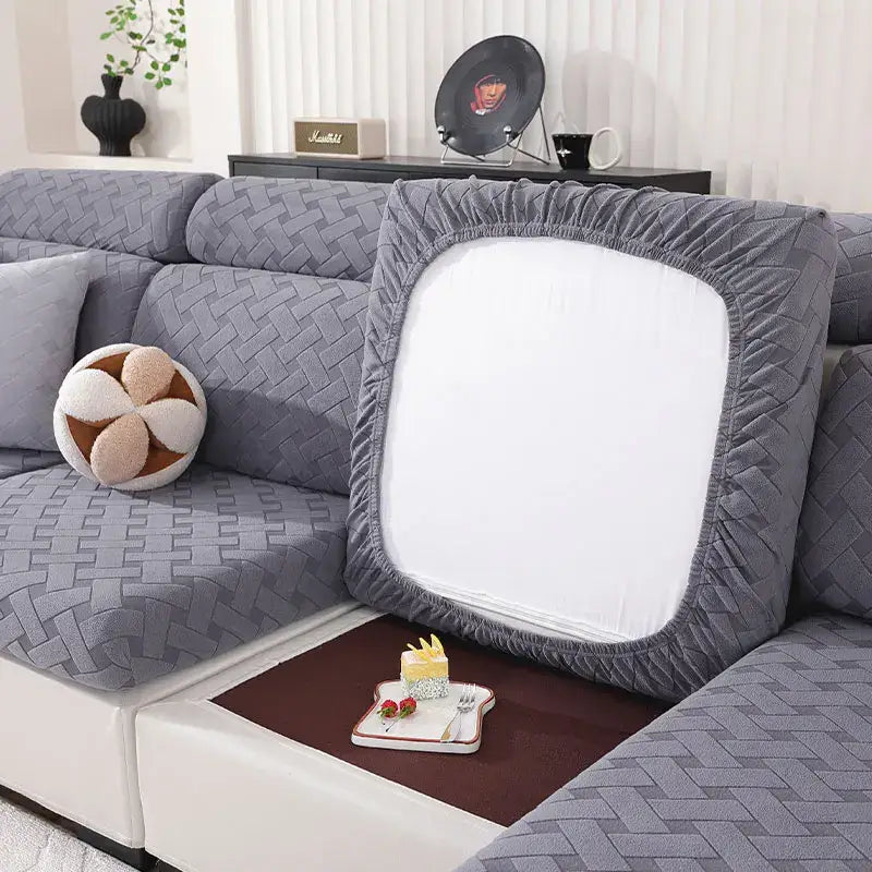 Gray and white woven elastic sofa slipcover showing gray quilted cushion cover with white central panel and elastic edges