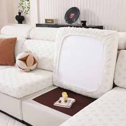 Gray and white woven elastic sofa slipcover with white textured fabric and elasticized edges for living room use