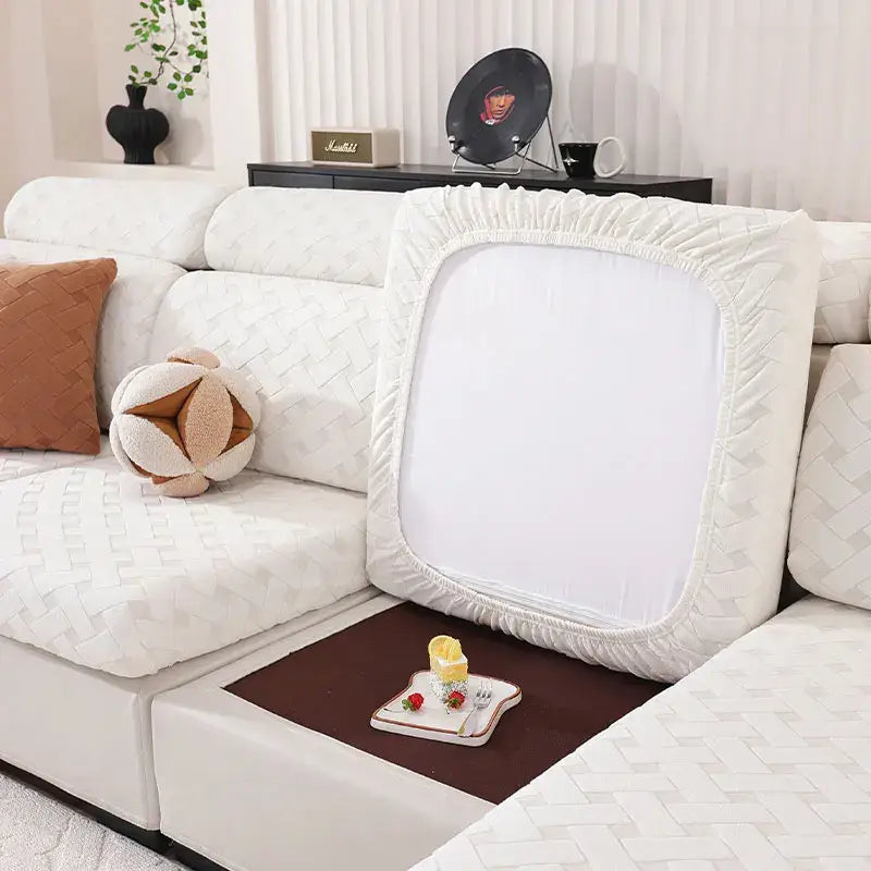 Gray and white woven elastic sofa slipcover with white textured fabric and elasticized edges for living room use