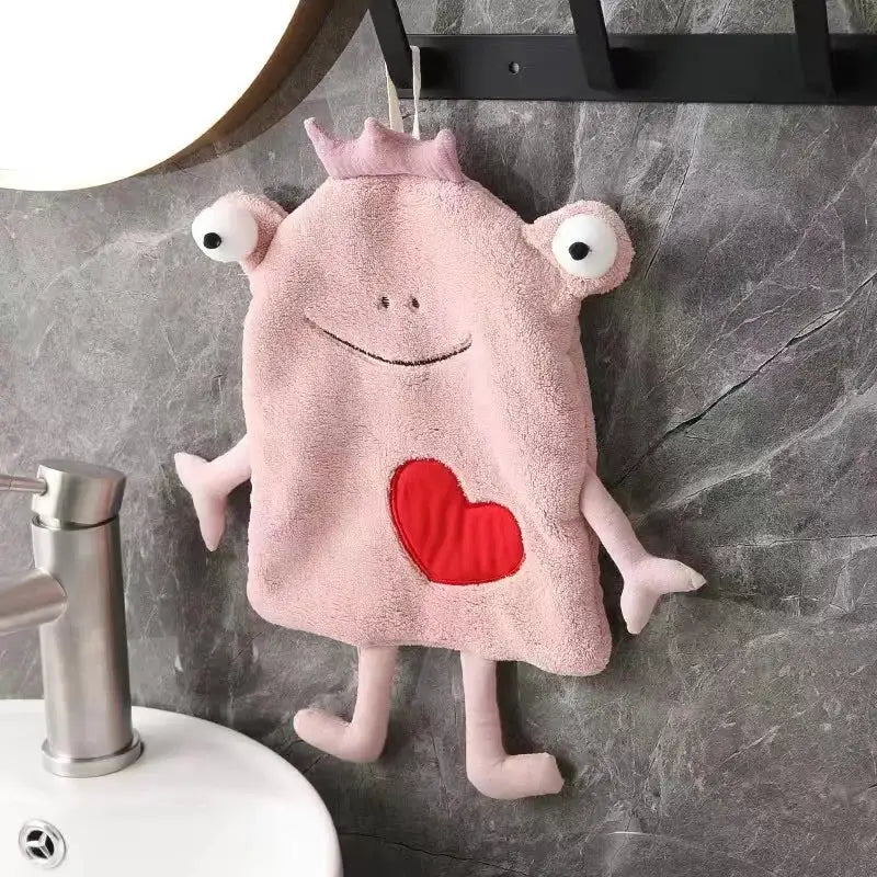 Pink plush hand towel shaped like a cartoon monster with embroidered eyes heart detail for decorbites frog design decor