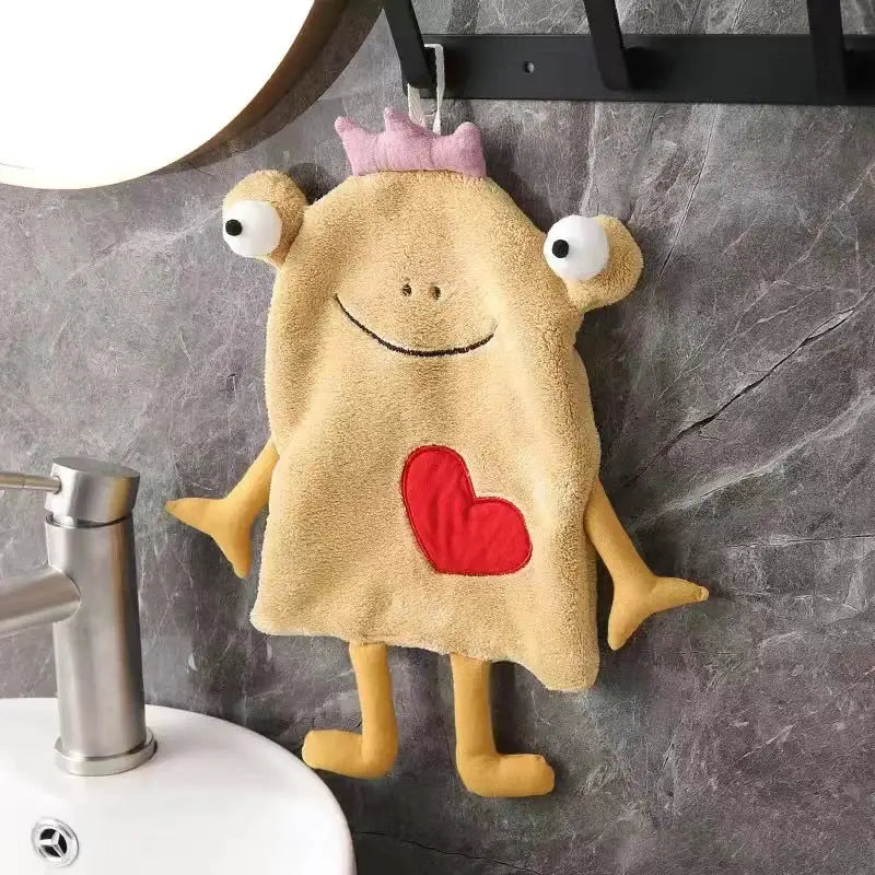 A plush tan hand towel shaped like a cartoon monster with embroidered eyes and red heart for decorbites frog design decor