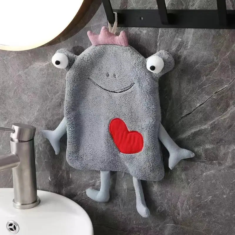 Gray plush hand towel with frog design features a pink crown white embroidered eyes and red heart patch decorbites frog design