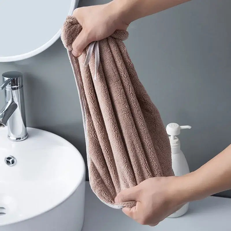 A plush taupe microfiber hair drying towel with white trim paired with gray and beige bowknot coral velvet hand towels decorbites