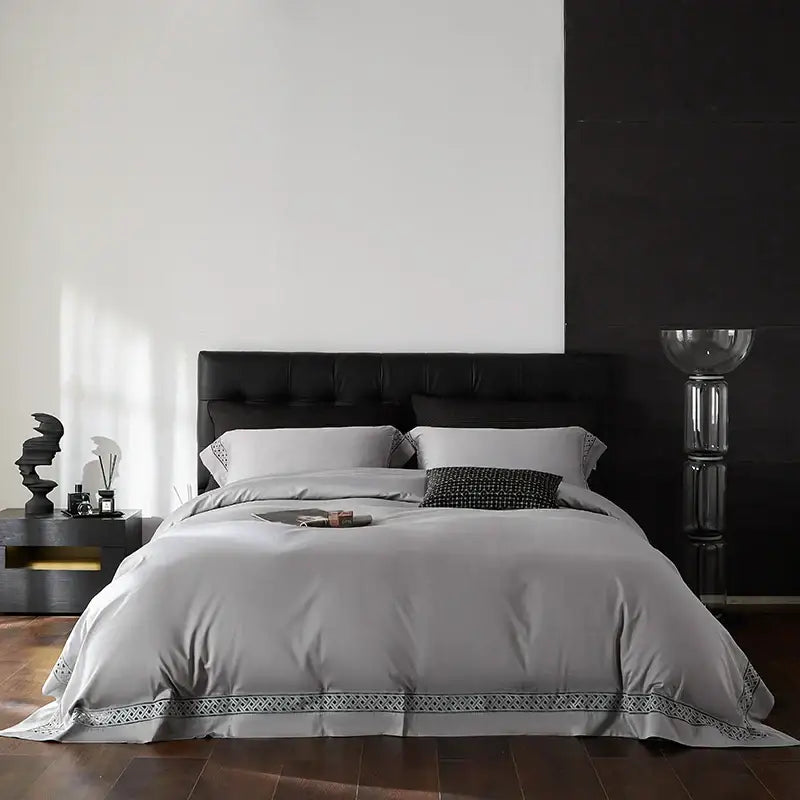 Gray satin duvet cover with subtle black geometric embroidery hem in egyptian cotton hotel bedding set