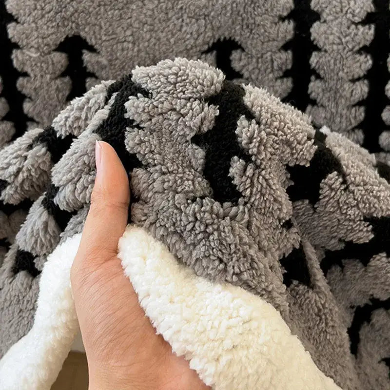 Cozy gray and black decorbites jacquard blanket made of thick lamb wool fleece with a soft plush texture for living room use