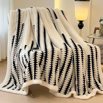 Cream-colored decorbites jacquard blanket with bold black geometric stripes made of thick lamb wool for living room use