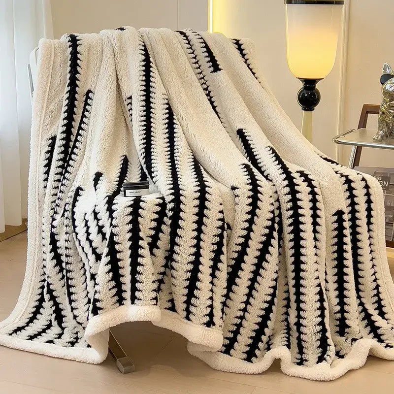 Cream-colored decorbites jacquard blanket with bold black geometric stripes made of thick lamb wool for living room use