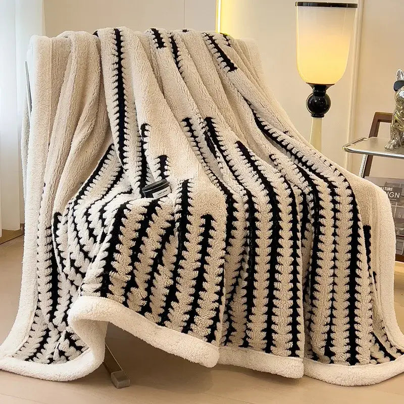 Cream-colored decorbites jacquard blanket with bold black stripes made of thick lamb wool for living room use