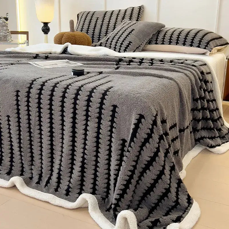 Gray plush decorbites jacquard blanket with black textured stripes and soft white fleece border for living room decor
