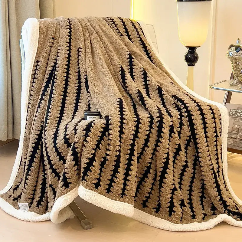 Tan and black plush decorbites jacquard blanket with textured zigzag pattern and white fleece border for living room use