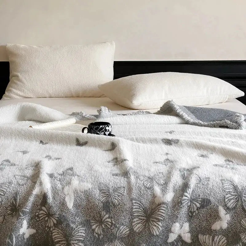 White throw blanket with soft textured surface and gray and white decorbites butterfly jacquard imitation mink fur design