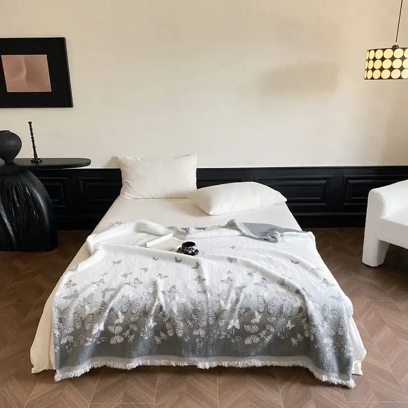 A soft white bedroom throw blanket with gray butterfly jacquard imitation mink fur and frayed edges decorbites butterfly jacquard