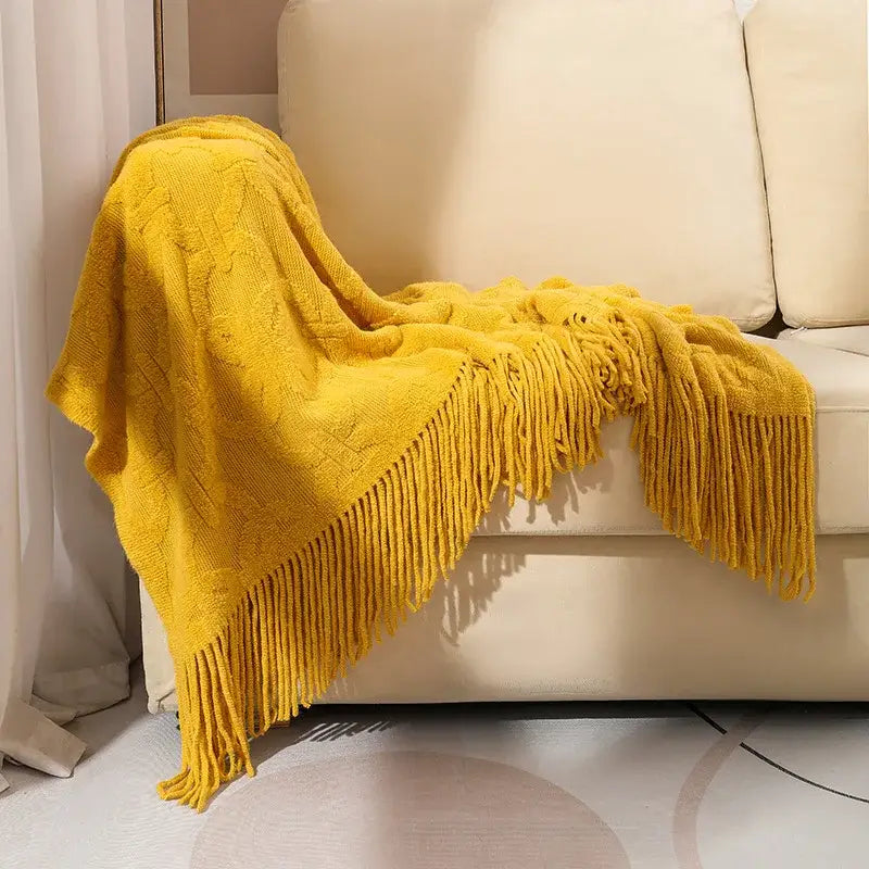 A cozy mustard-yellow knit blanket with cable knit pattern and long fringe for knit blanket sofa decorbites knit blanket