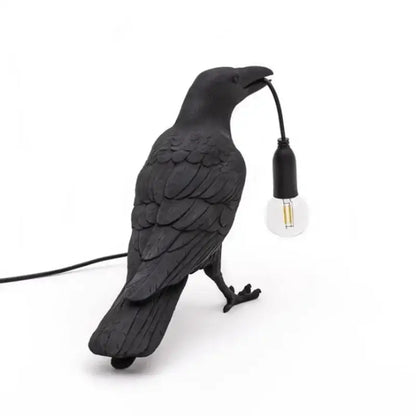 Black ceramic lively bird resin table lamp with textured feathers and exposed bulb held in beak for bedroom decorbites lively bird