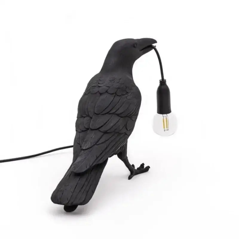 Black ceramic lively bird resin table lamp with textured feathers and exposed bulb held in beak for bedroom decorbites lively bird