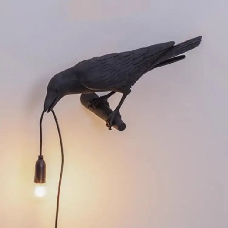 Black crow-shaped lively bird resin table lamp with matte finish and exposed bulb on branch base for bedroom decorbites lively bird