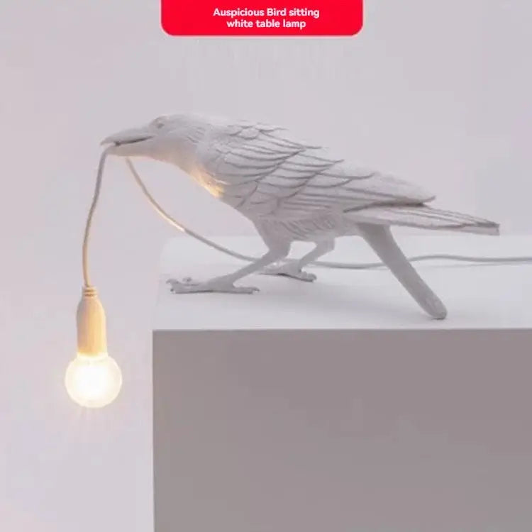 Gray ceramic lively bird resin table lamp with white ceramic bird holding glowing bulb in beak for bedroom decorbites lively bird