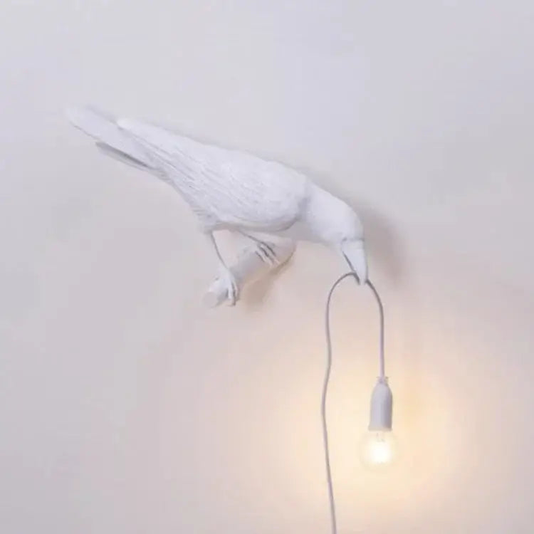 White ceramic bird wall lamp with dangling bulb complementing decorbites lively bird resin table lamp for bedroom