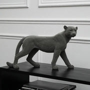 Gray concrete leopard flocking sculpture with textured spotted surface and sleek lifelike posture for living room decor