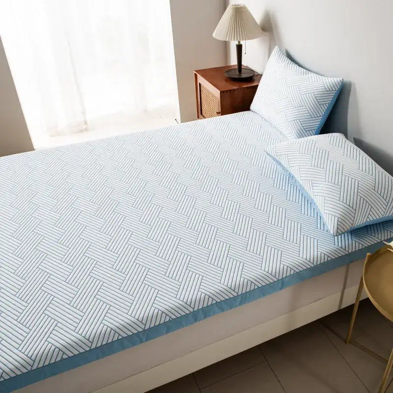 Light blue woven-patterned bed sheet set with matching pillowcases complements gray cooling ice bean mesh quilted mattress pad