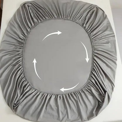 Gray decorbites cotton fitted sheet set featuring a smooth, slightly shiny elastic gray fitted sheet with gathered edges