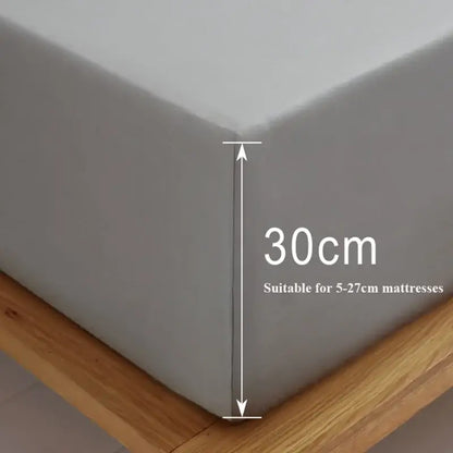 Gray decorbites cotton fitted sheet set featuring a smooth textured gray fitted sheet snugly covering a mattress corner