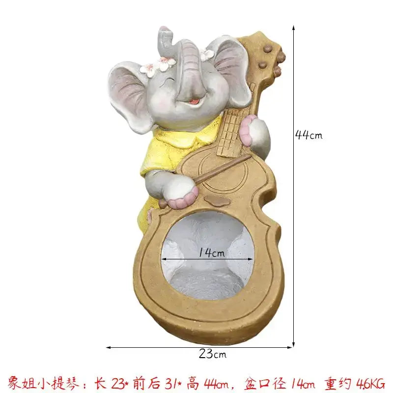Gray ceramic elephant garden decoration wearing a yellow dress holding a guitar-shaped planter with white flowers