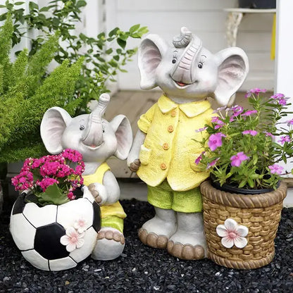 Gray ceramic elephant garden decoration with yellow outfits holding a soccer ball planter and pink flowers basket