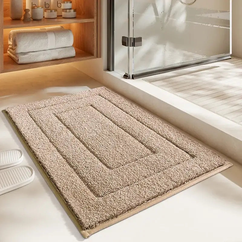 Beige plush bath mat with textured rectangular pattern and soft looped pile from decorbites geometric flocked bath collection