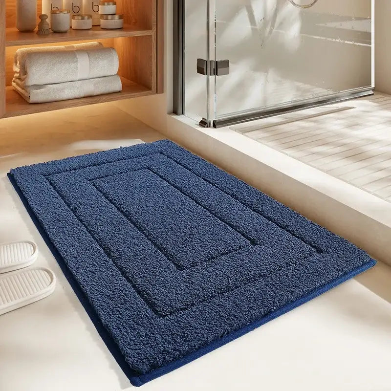 Deep blue plush rectangular bath mat with textured looped pile and geometric border decorbites geometric flocked bath mat