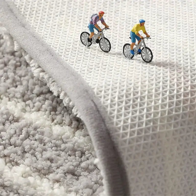Gray geometric flocked plush bath mat showing white mesh backing featuring decorbites geometric flocked design