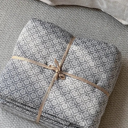 Gray geometric linen cotton jacquard bedding set with white floral pattern tied with natural twine for decorbites linen cotton decor