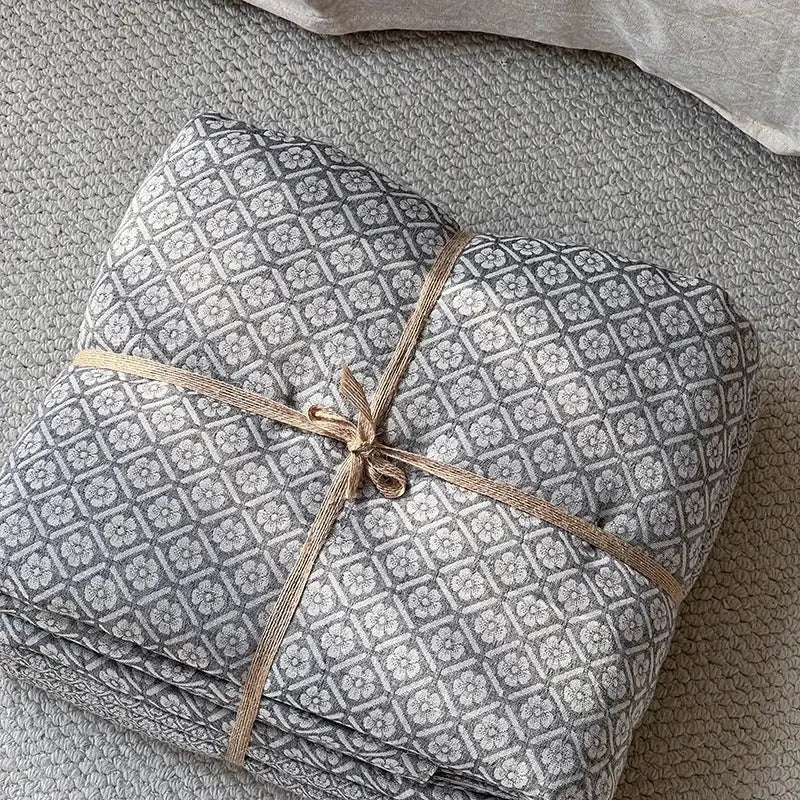 Gray geometric linen cotton jacquard bedding set with white floral pattern tied with natural twine for decorbites linen cotton decor