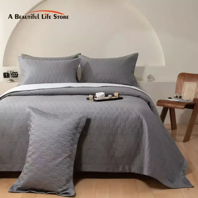 Gray geometric quilted bedspread set made of egyptian cotton with matching pillows for bedroom use