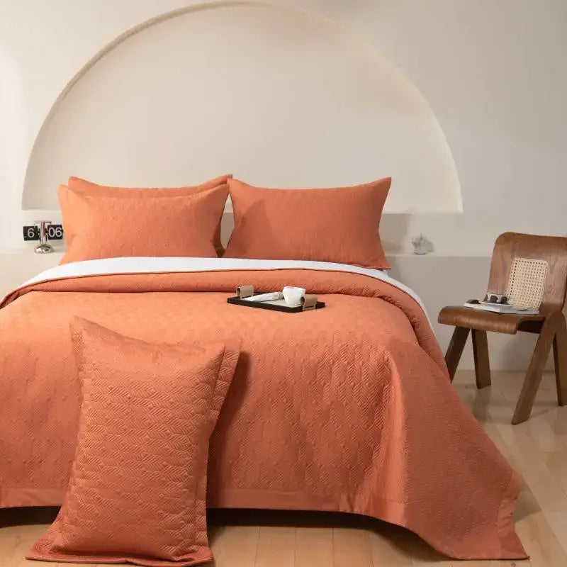Coral-colored quilted bedspread set with subtle texture made of egyptian cotton for bedroom use