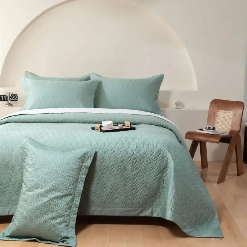 Soft mint green quilted bedspread set with subtle diamond pattern and white border made of egyptian cotton