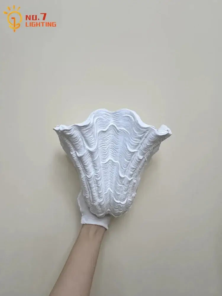 White gypsum shell led wall lamp with intricately textured sculpted design ideal for bedroom sconce lighting