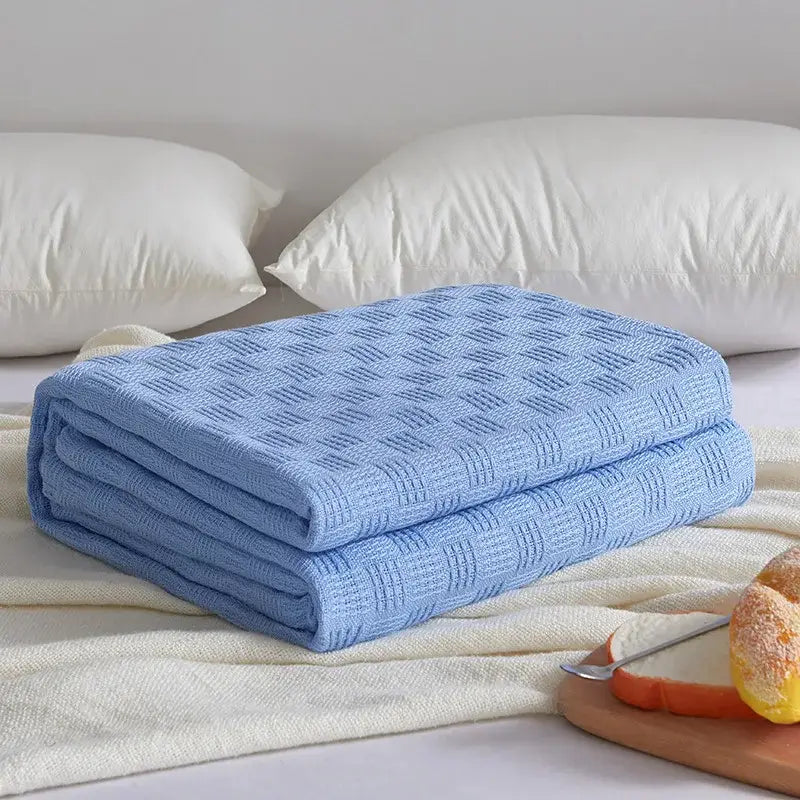 Soft light blue knitted decorbites cotton waffle towel quilt with textured pattern for bedroom or office decor