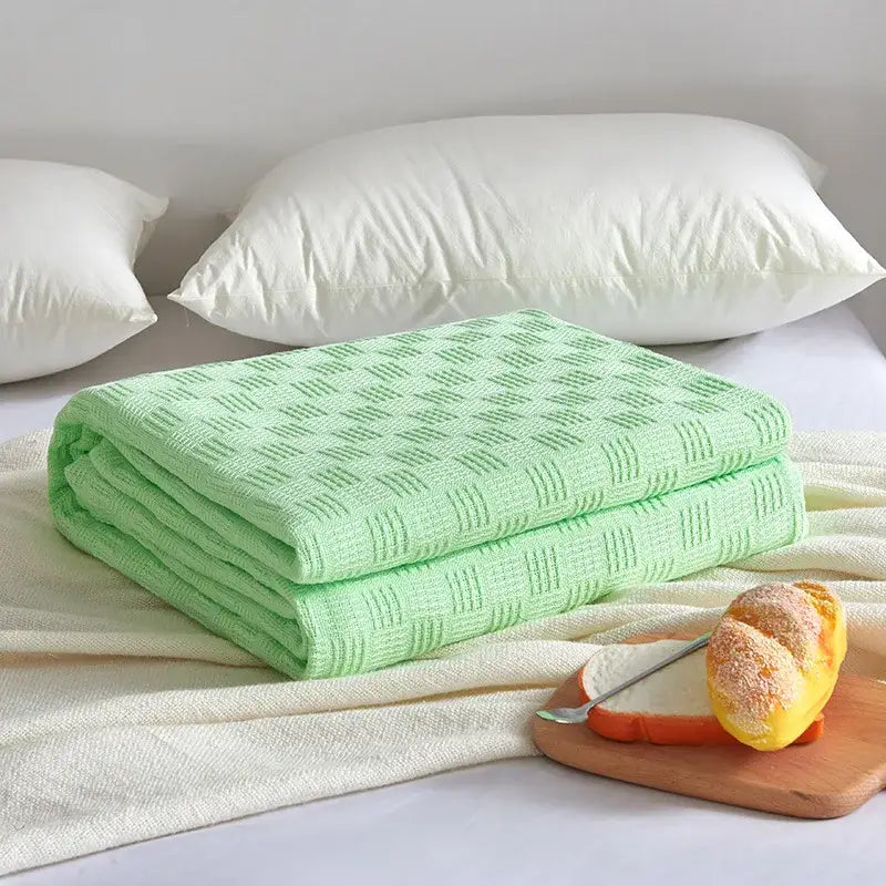 Gray herringbone cotton waffle towel quilt featuring a soft light green woven diamond pattern for bedroom or office decorbites cotton waffle